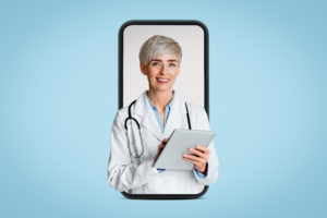 Médica na tela de um celular segurando um tablet em fundo azul
